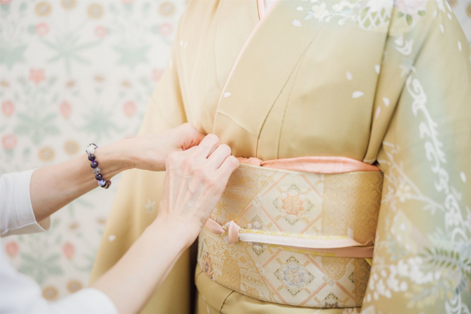 Tying the obi during kimono dressing